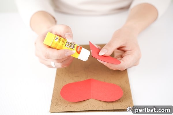 Gluing paper heart to craft paper