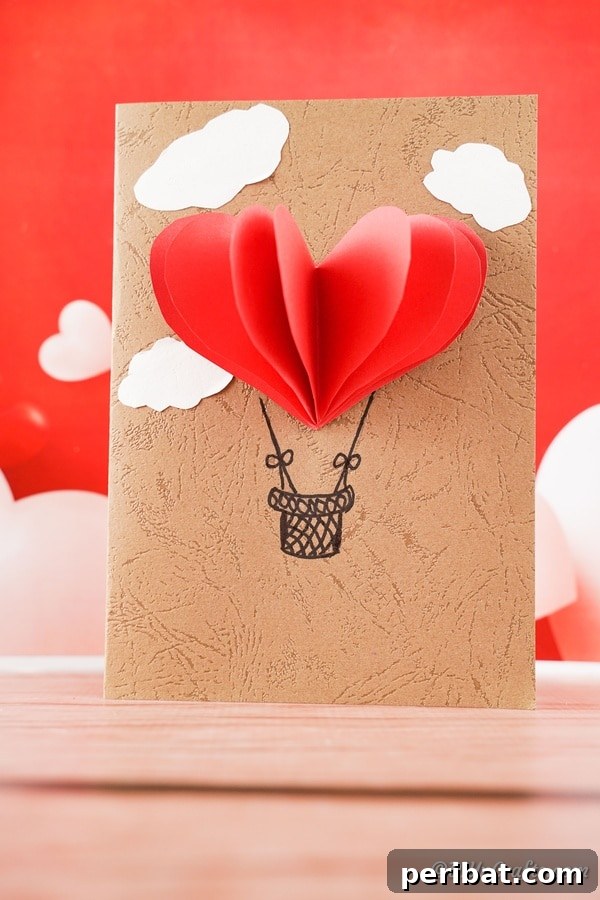 Hot air balloon 3D valentine's day card sitting on table with red background
