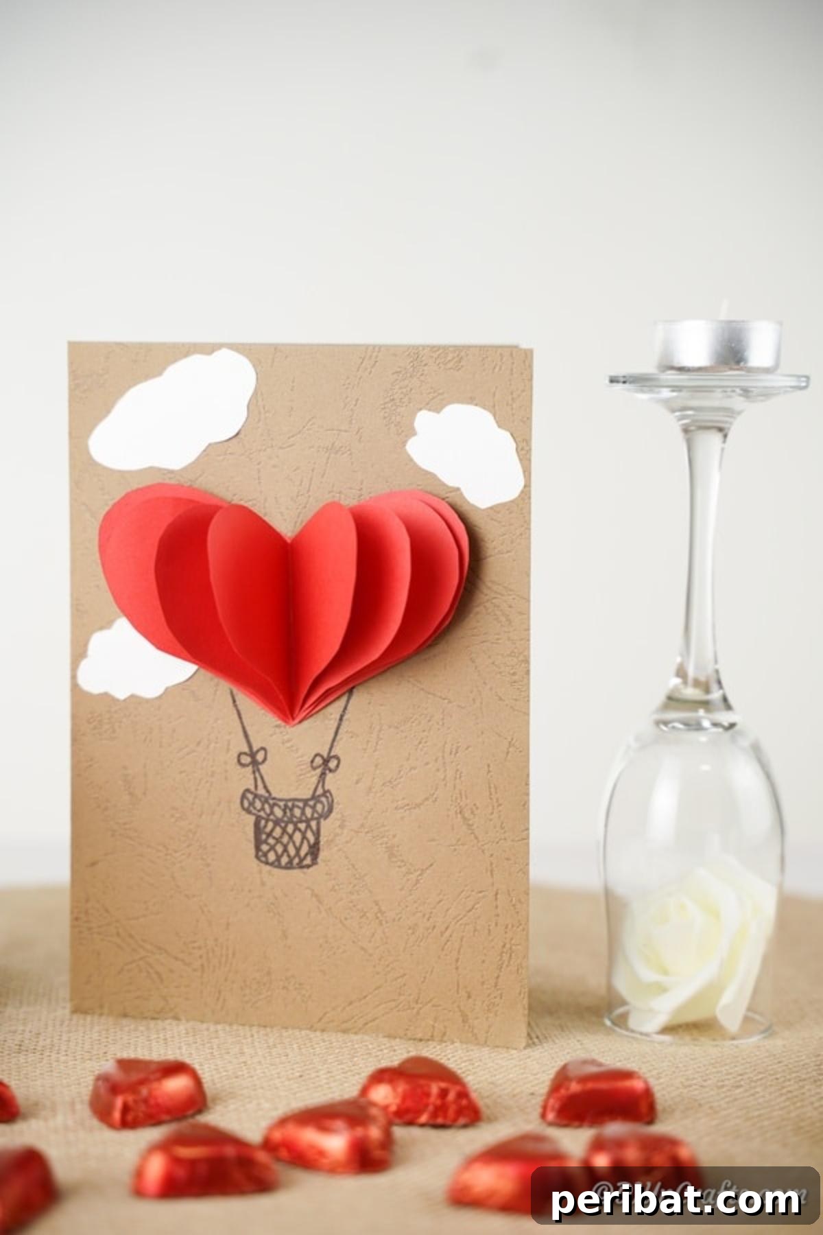 Hot air balloon card next to wine glass