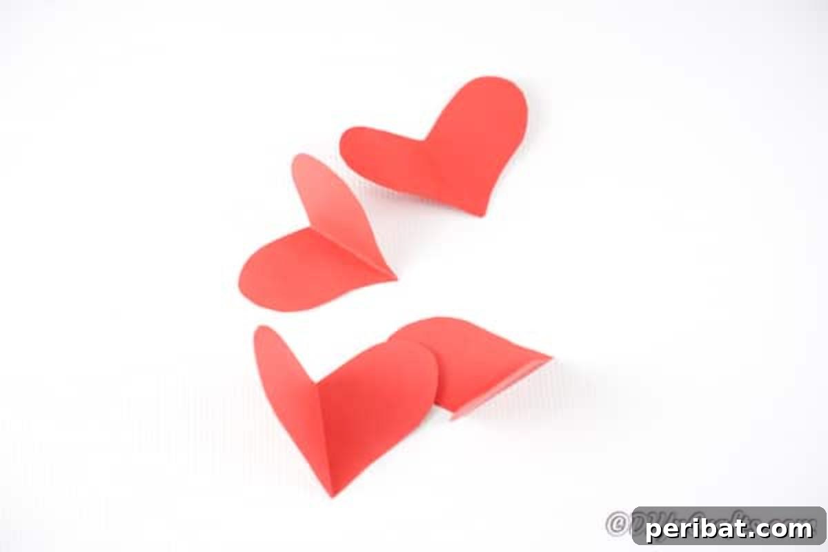Cutting hearts out of red craft paper