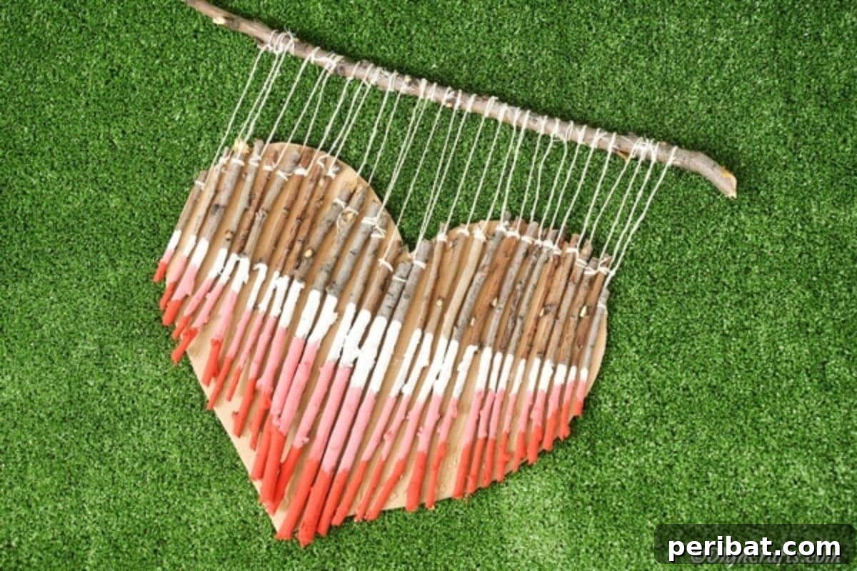 Hand-Painted Rustic Twig Heart Ornament 19 Painted red pink and white twig heart laying on grass
