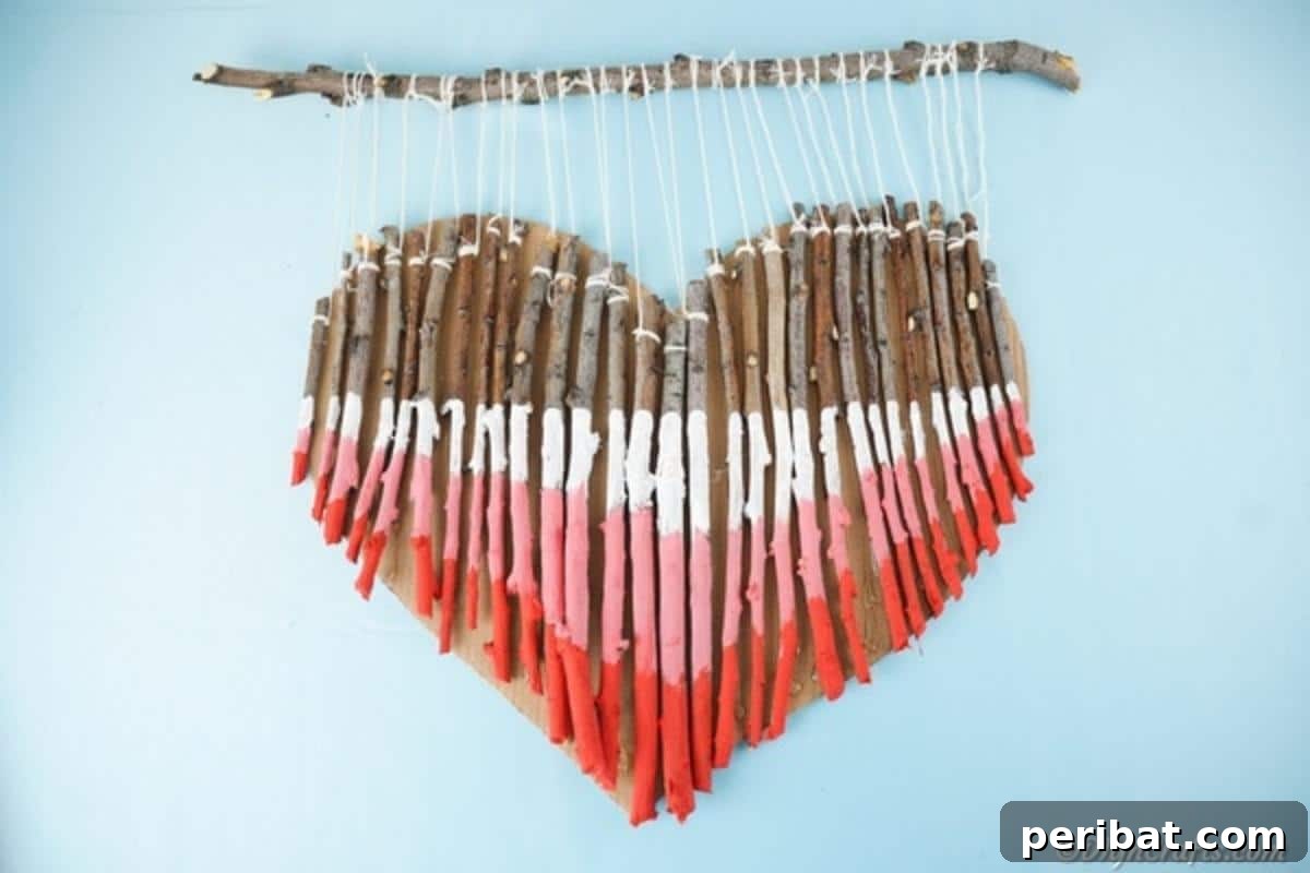 Hand-Painted Rustic Twig Heart Ornament 3 Painted twig wooden heart wall art on blue wall