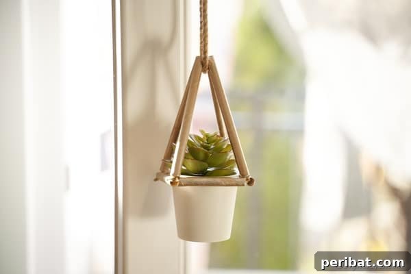 A beautiful succulent planter crafted from paper straws hangs delicately in a window, showcasing a brilliant DIY home decor idea.