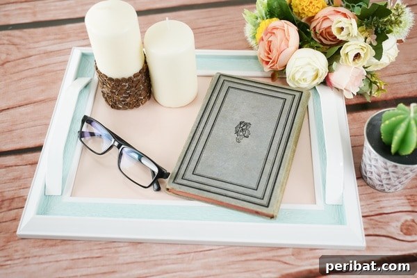 Picture frame tray with candles and journal on top