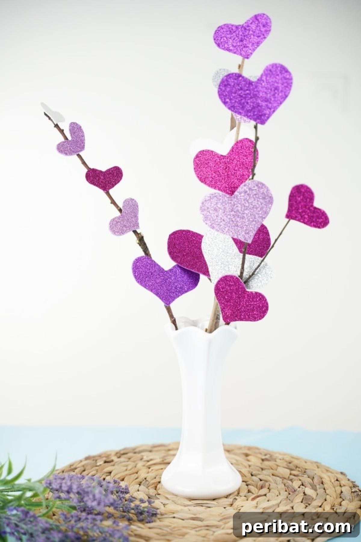 White vase on woven mat filled with heart flowers