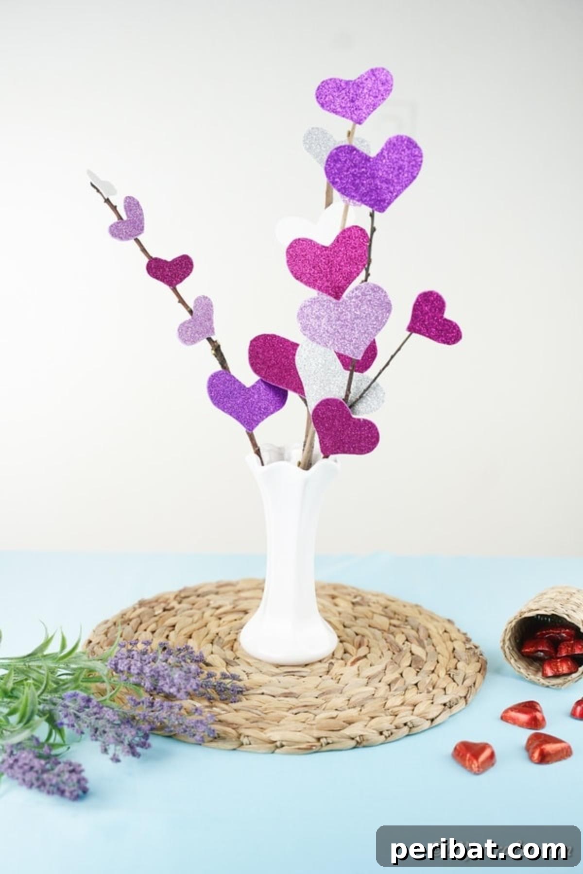 Heart flower bouquet in white vase on blue surface