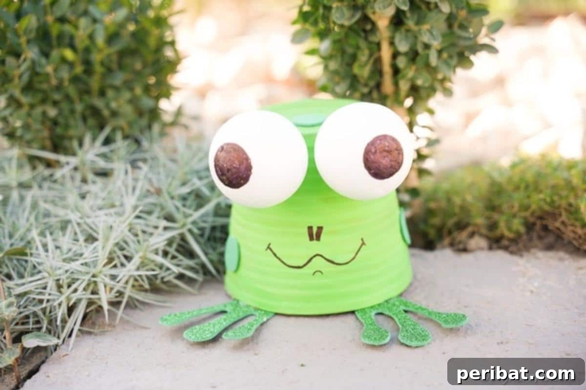 Whimsical Upcycled Flowerpot Frog Garden Art 15 The finished upcycled flower pot garden frog, painted green with expressive eyes and glitter feet, sitting serenely on a concrete sidewalk, ready for display.