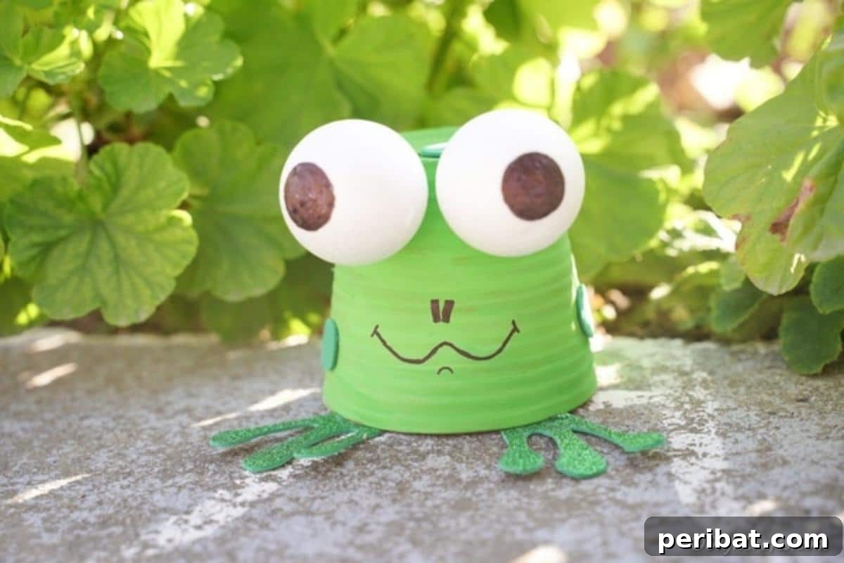 Whimsical Upcycled Flowerpot Frog Garden Art 3 A charming upcycled flower pot frog, painted green and adorned with glitter feet, sits gracefully on a sidewalk amidst green foliage, ready to greet garden visitors.