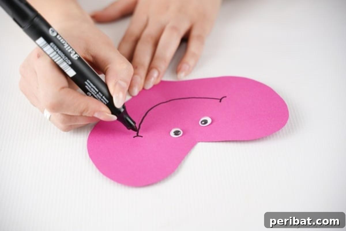 Little Hands, Loving Hearts: Kids' Valentine Paper Craft 13 Attaching googly eyes to the main paper heart body