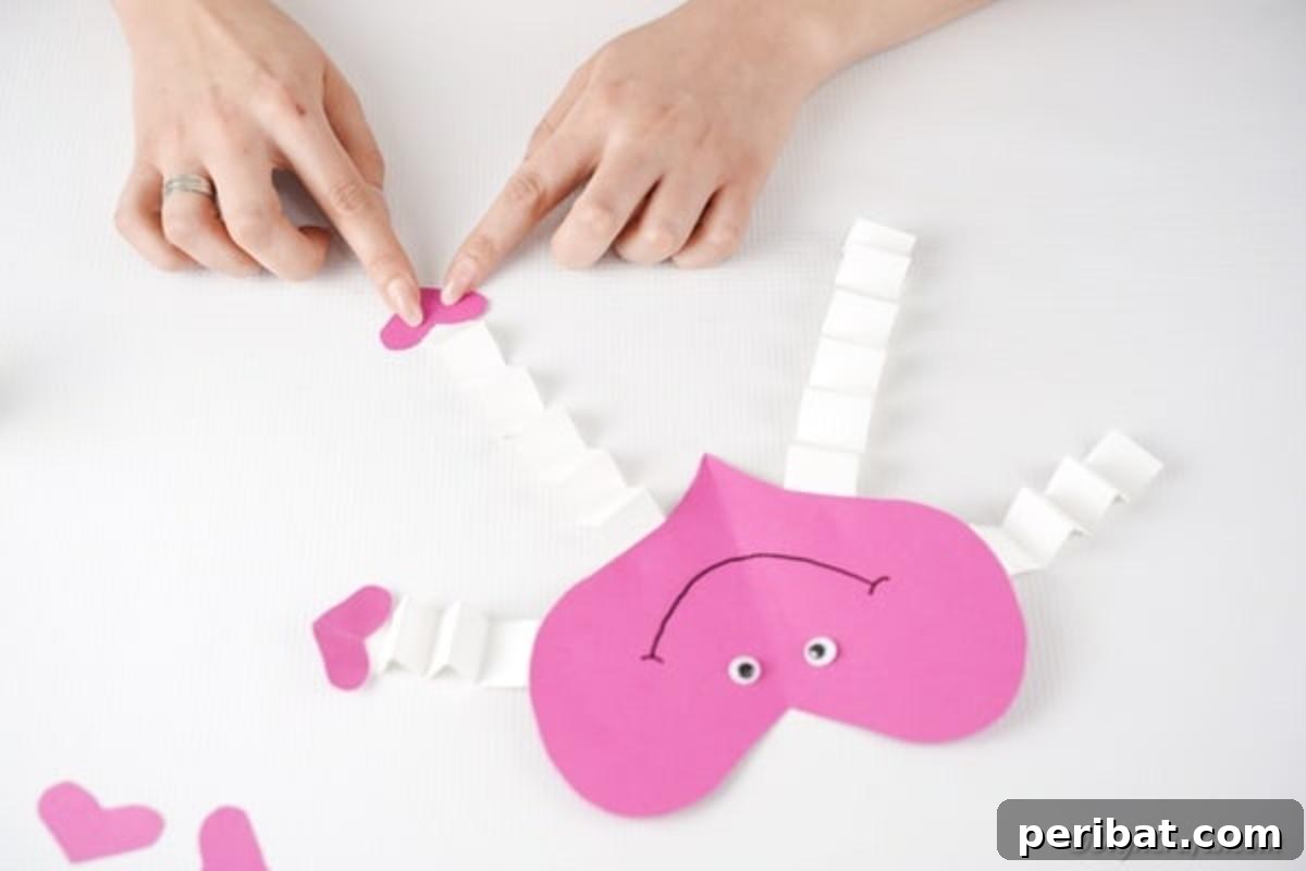 Little Hands, Loving Hearts: Kids' Valentine Paper Craft 15 Attaching small hearts to the ends of the arms and legs as hands and feet