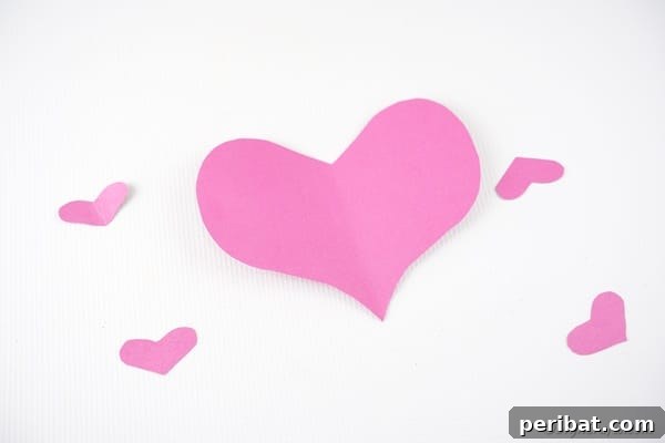 Little Hands, Loving Hearts: Kids' Valentine Paper Craft 18 Hearts in two sizes on white surface