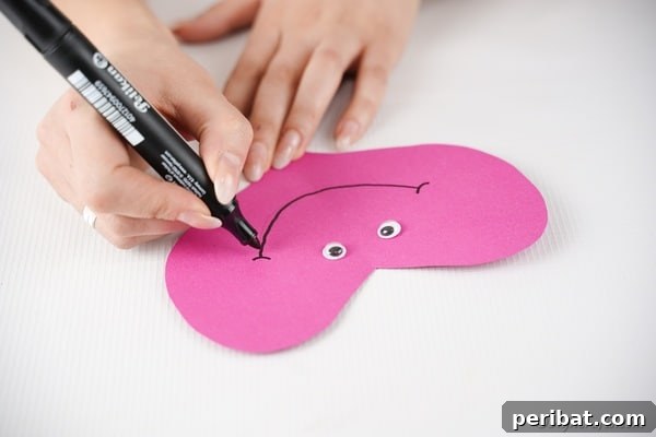 Little Hands, Loving Hearts: Kids' Valentine Paper Craft 22 Attaching googly eyes to paper heart