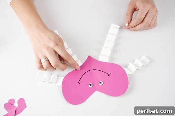 Little Hands, Loving Hearts: Kids' Valentine Paper Craft 23 Attaching arms and legs to paper heart