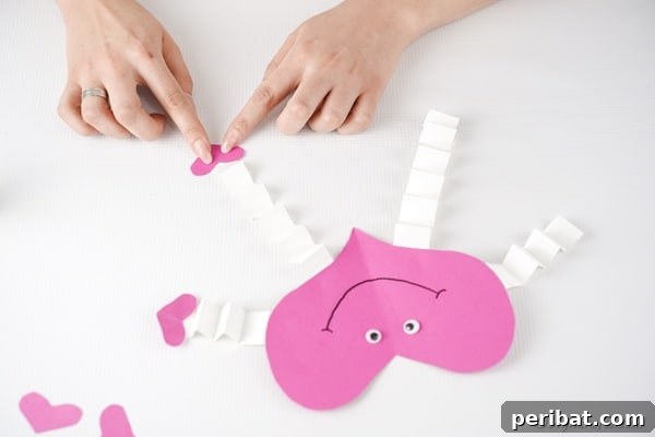 Little Hands, Loving Hearts: Kids' Valentine Paper Craft 24 Attaching hearts to ends of arms and legs