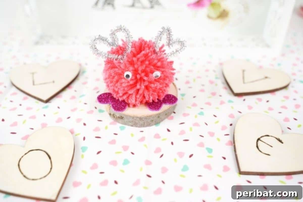 Pom pom monster on white polka dot surface