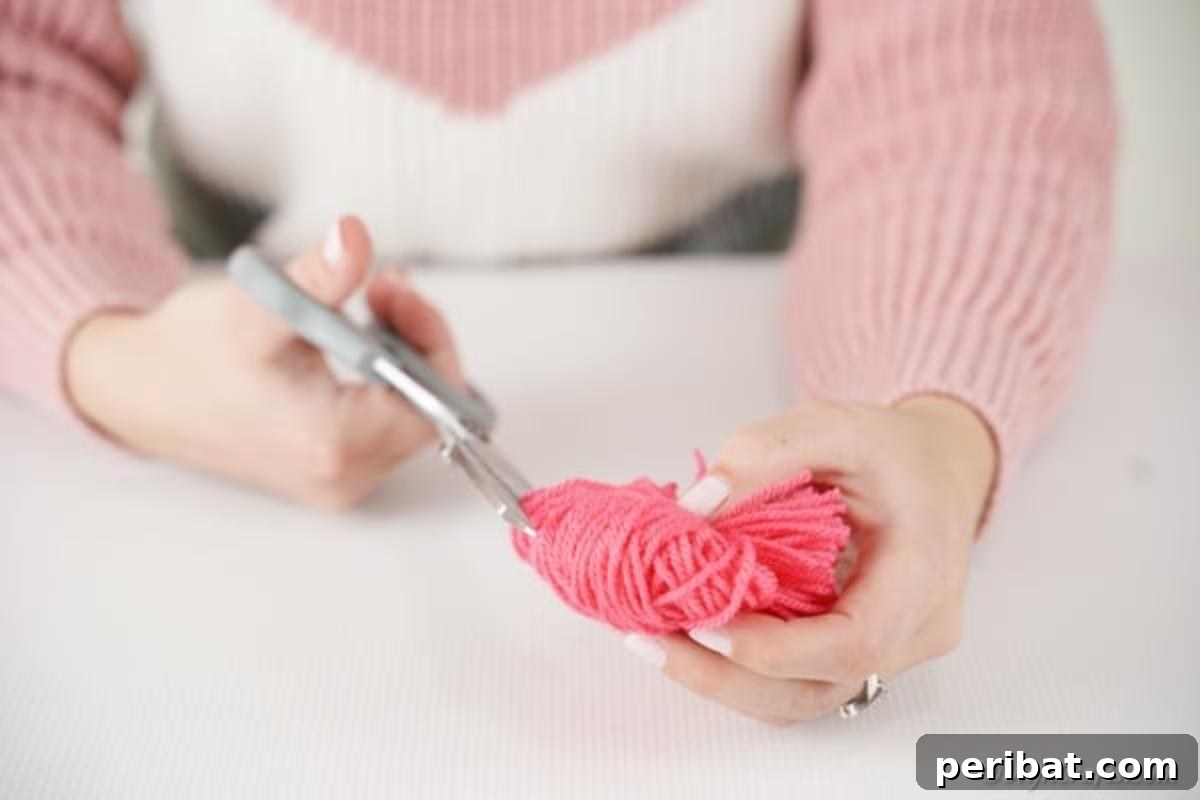 Cutting loops of yarn on pom pom monster
