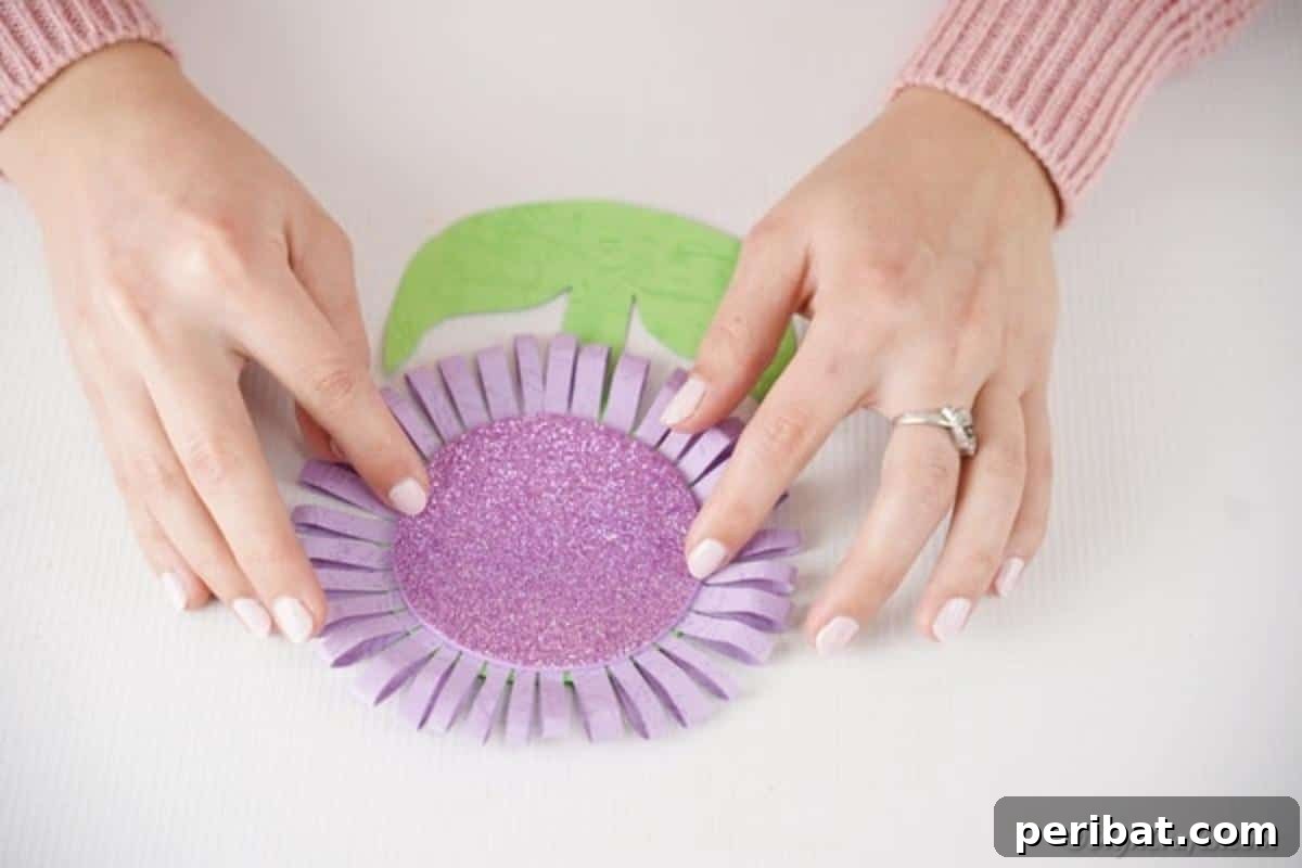 Craft Your Own Paper Flower Photo Keepsake 13 Placing the purple glitter paper onto the middle of the paper flower