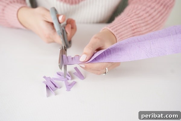 Craft Your Own Paper Flower Photo Keepsake 19 Cutting fringe on purple paper