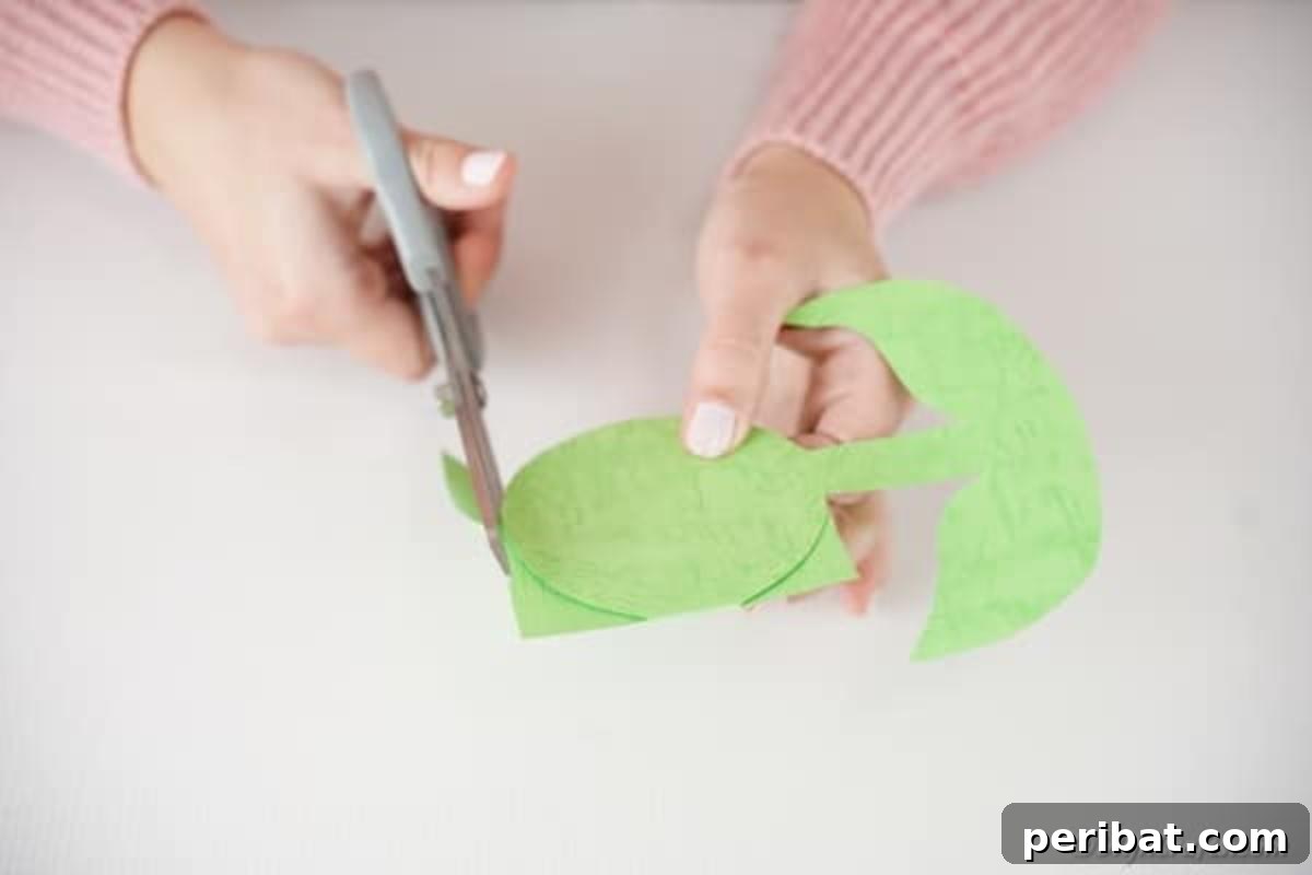 Craft Your Own Paper Flower Photo Keepsake 8 Cutting out the green flower base, stem, and leaves from paper