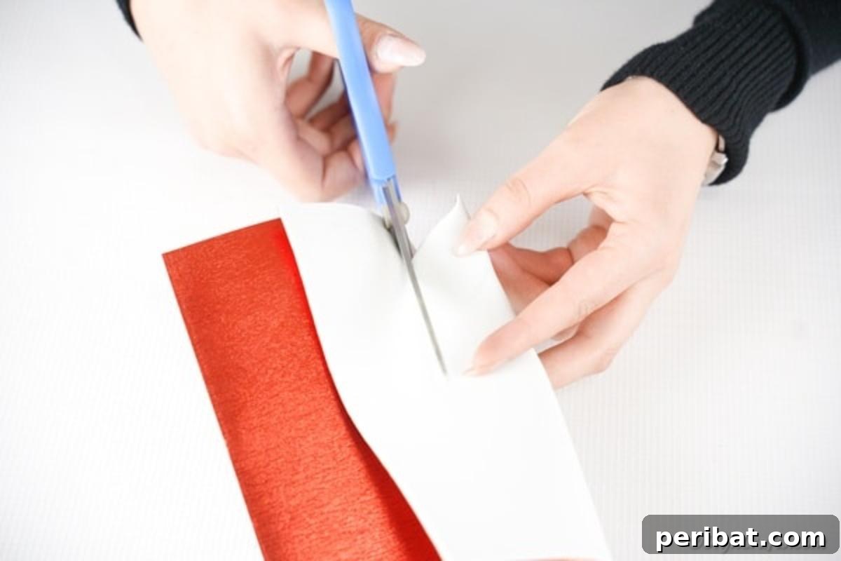 Make Your Own Valentine's Love Arrows 7 Hands carefully cutting out heart shapes from red glitter foam paper for the Valentine's craft