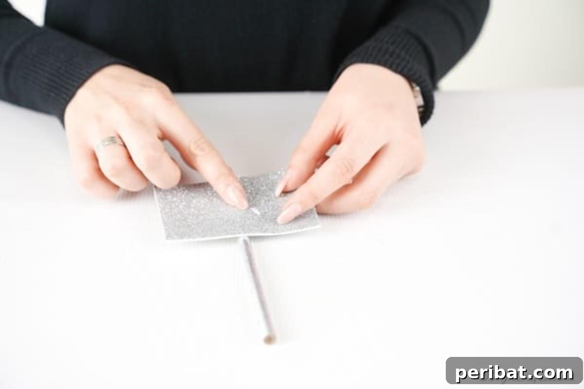 Make Your Own Valentine's Love Arrows 9 Attaching a silver foam paper rectangle near the eraser end of a pencil