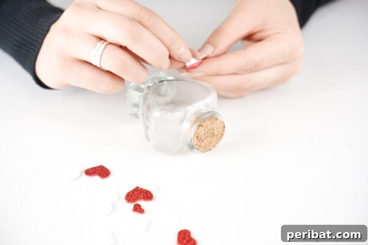 Gluing hearts on outside of bottle