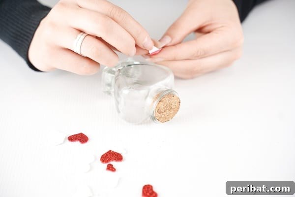 Gluing hearts on outside of bottle