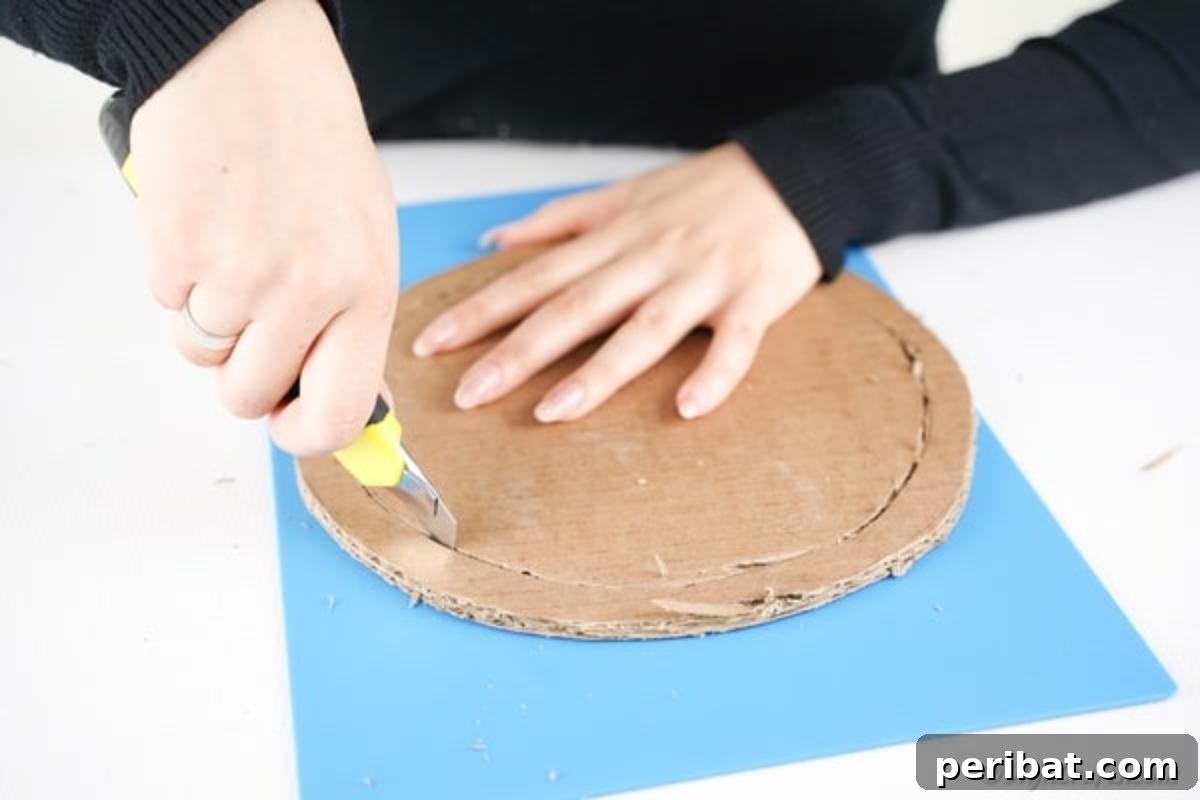 Cutting out wreath form from cardboard