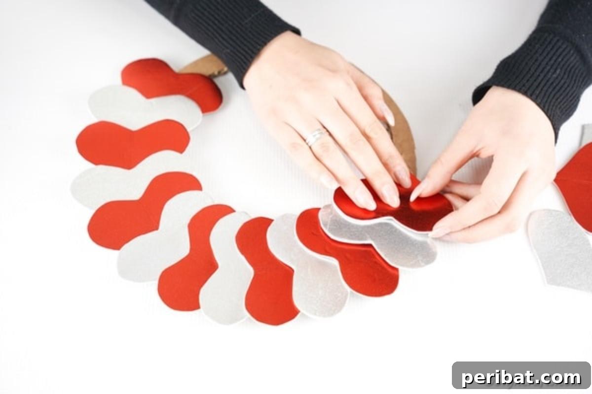 Adding red and silver hearts to cardboard form