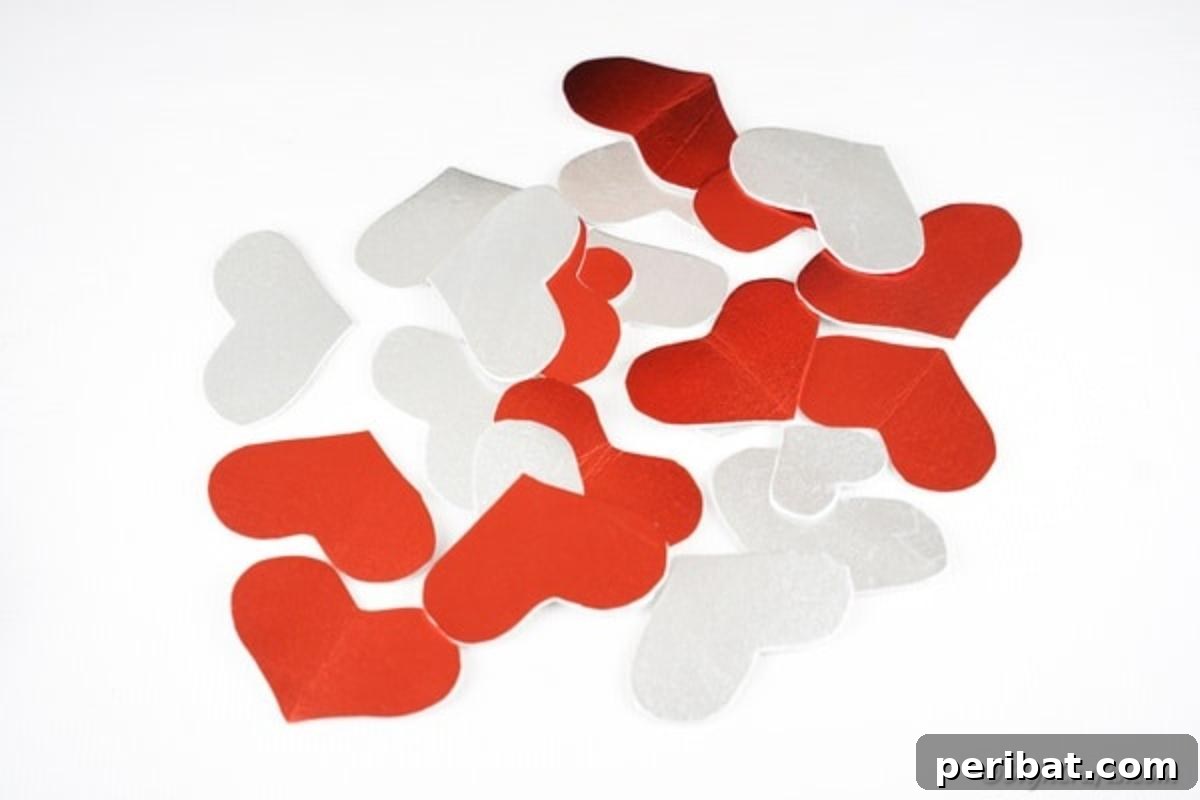 Silver and red hearts on a white table