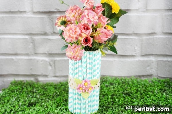 Mason jar vase with colorful straws in front of a brick wall