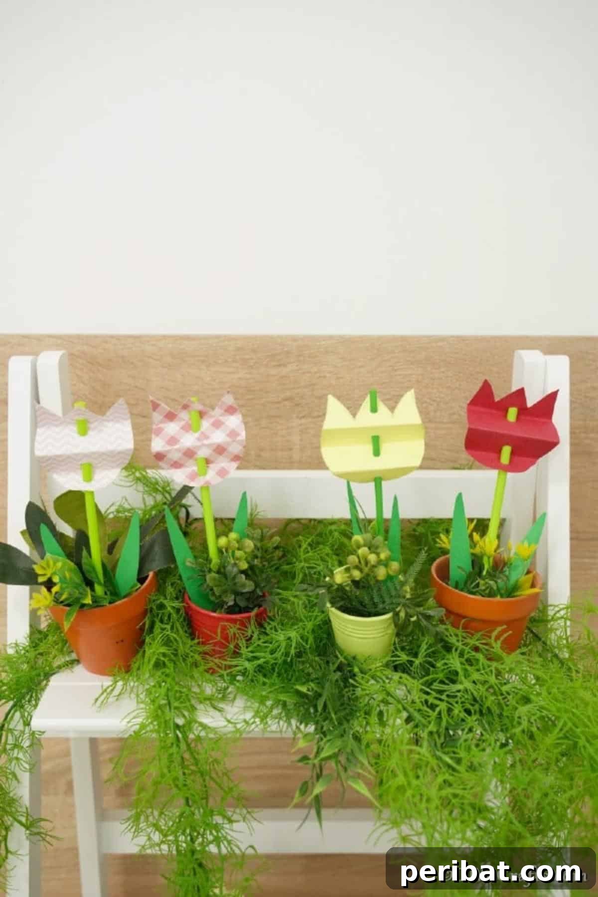 Create Charming Spring Paper Tulips 5 Arrangement of colorful paper tulips in small flower pots on a shelf, surrounded by green herbs