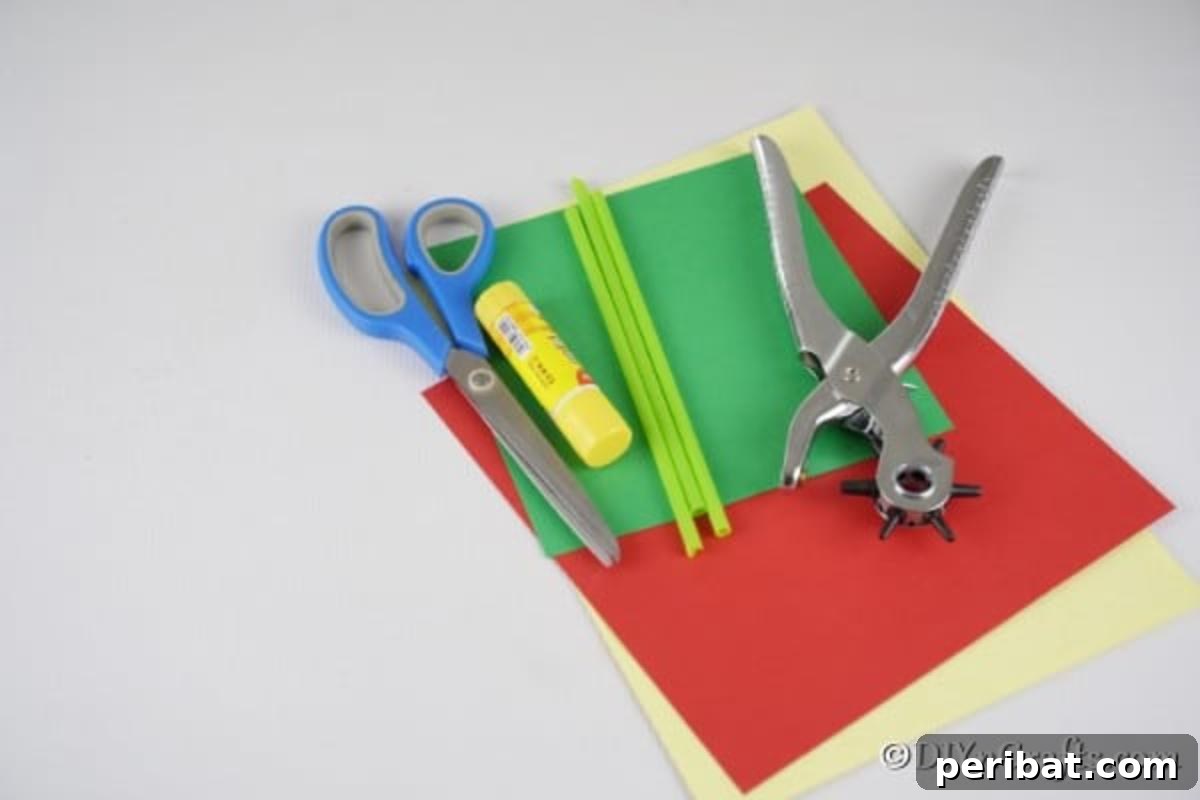 Create Charming Spring Paper Tulips 7 A flat lay of all the supplies needed for crafting paper tulips, including colored paper, straws, scissors, and glue stick