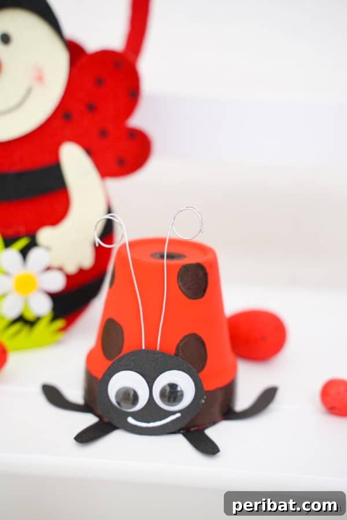 Adorable Upcycled Ladybug Planter Craft 3 A finished ladybug flower pot craft displayed on a pristine white shelf, ready for indoor or outdoor enjoyment.