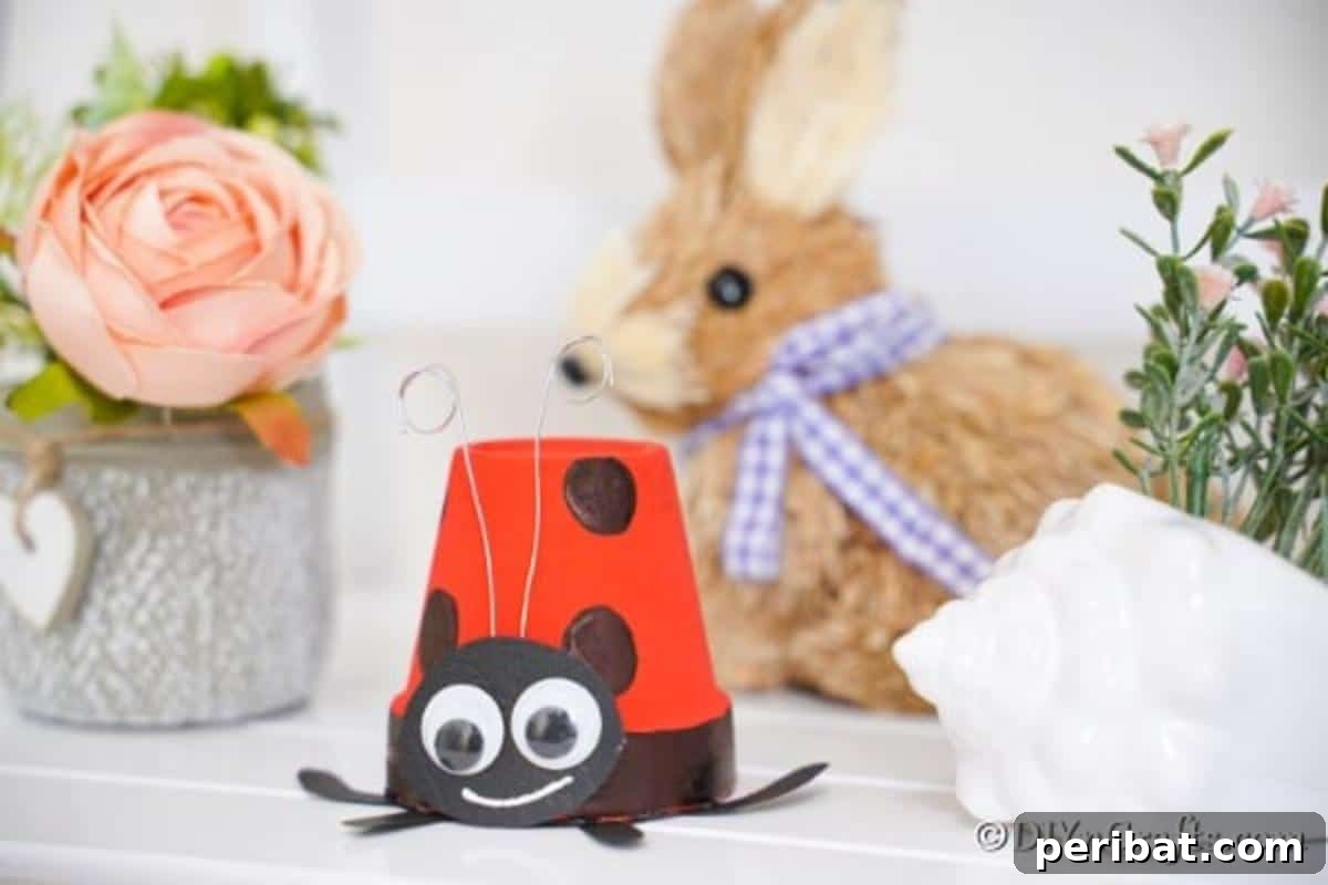 Adorable Upcycled Ladybug Planter Craft 6 A delightful display featuring the ladybug planter on a counter alongside a charming bunny figurine.