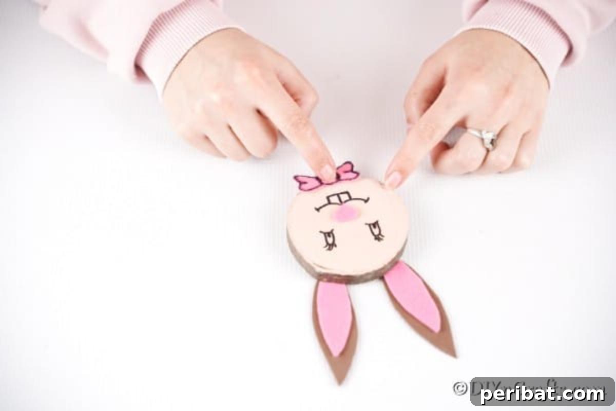 Crafting Whimsical Wood Slice Easter Bunnies 16 Adding a felt bow tie to the Easter bunny wood slice for a dapper look.