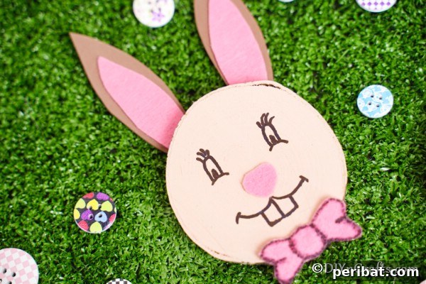 Wood slice Easter bunny on fake grass, an image often used for social sharing.
