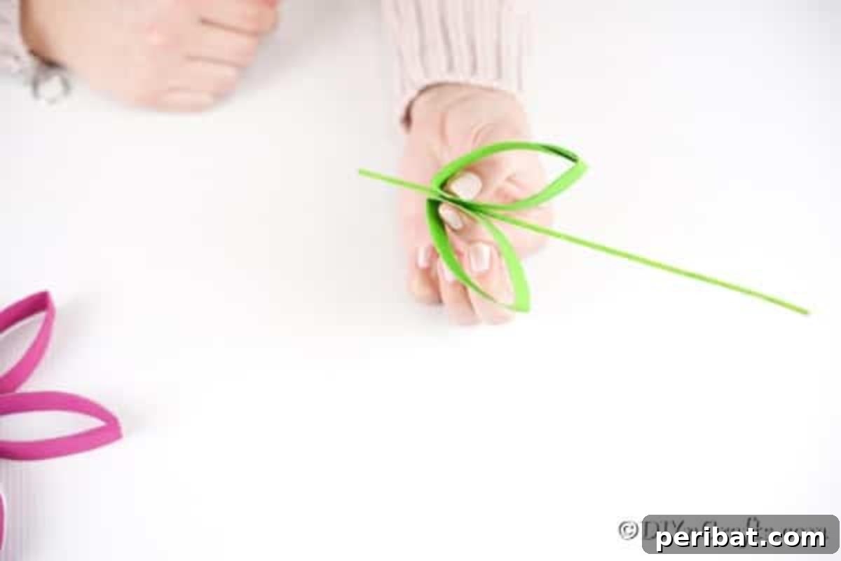 Adding two green leaves to the skewer for the flower stem