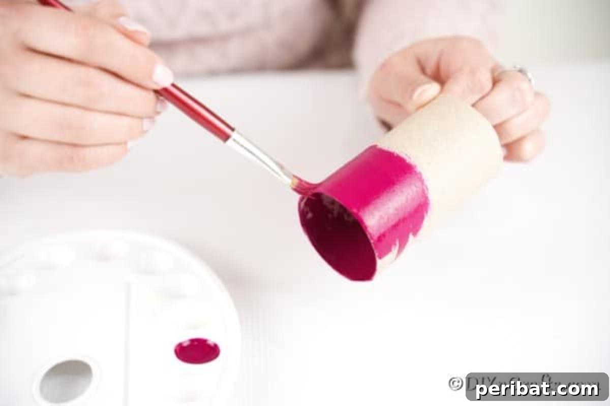 Painting toilet paper roll pink