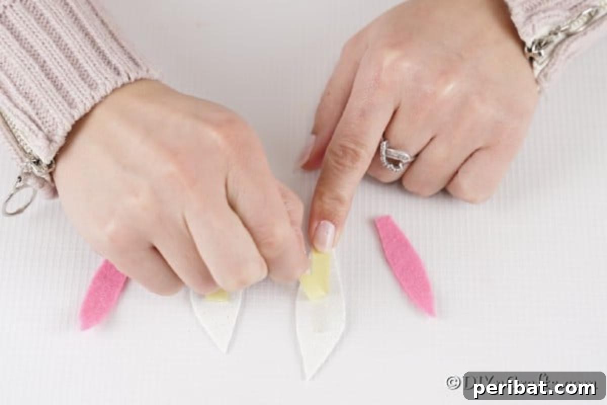 Craft Adorable Easter Bunny Eggs 11 Taping ears together for bunny egg