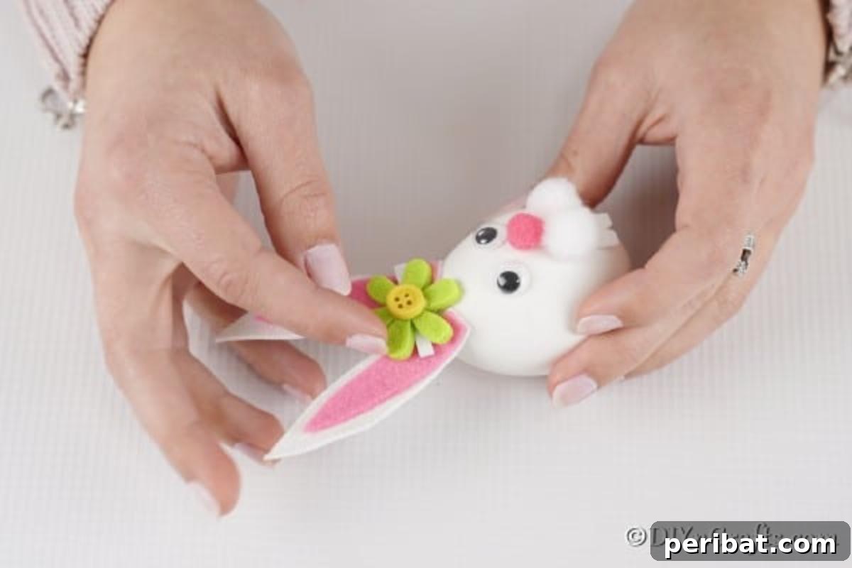 Craft Adorable Easter Bunny Eggs 14 Adding a flower between ears on Easter egg bunny