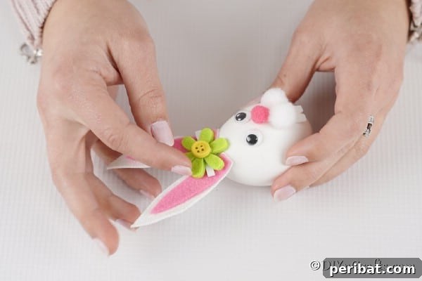 Craft Adorable Easter Bunny Eggs 23 Adding a flower between ears on Easter egg bunny