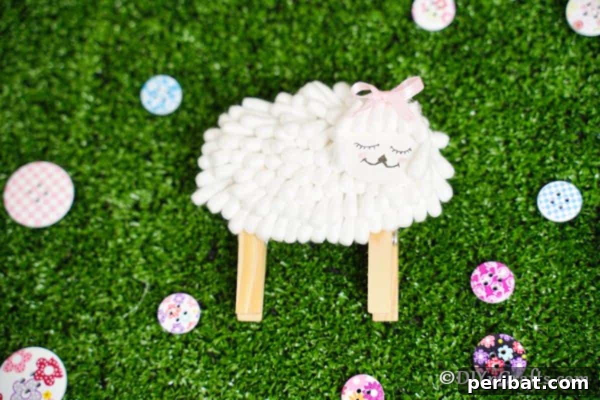 Cotton swab lamb sitting on artificial green grass with colorful buttons scattered around, adding vibrancy.