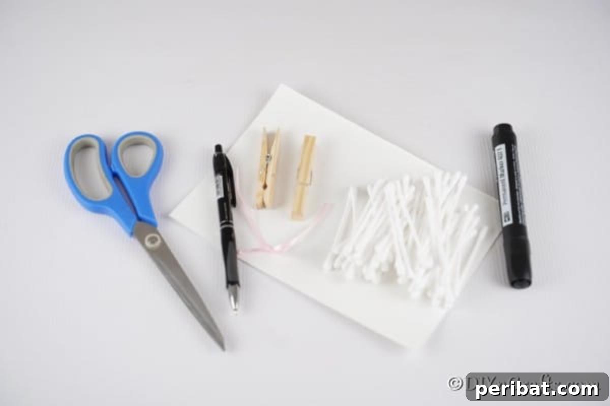Assortment of craft supplies including cotton swabs, paper, scissors, glue, and clothespins, ready for the lamb craft.