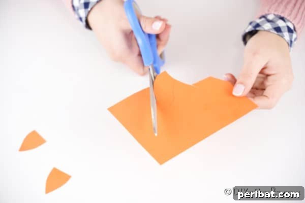 Foxy Fun DIY Easter Egg Project 14 Step-by-step image showing the cut-out orange ears and tail for the fox egg.
