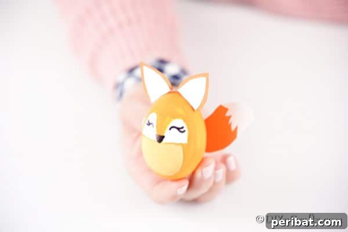 Foxy Fun DIY Easter Egg Project 19 A completed Easter egg fox decoration held gently in a woman's hand, showcasing the finished craft.