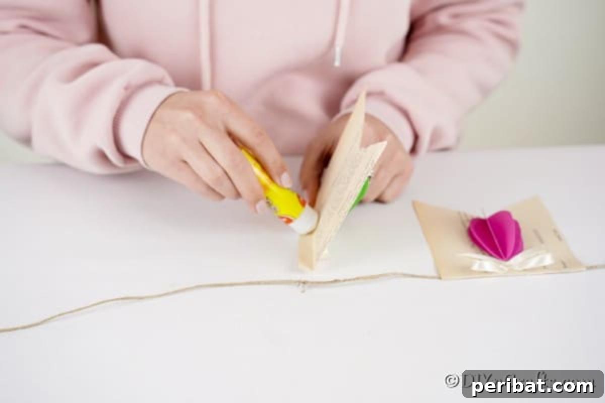 DIY Upcycled Book Page Easter Egg Garland Tutorial 19 Gluing banner to twine