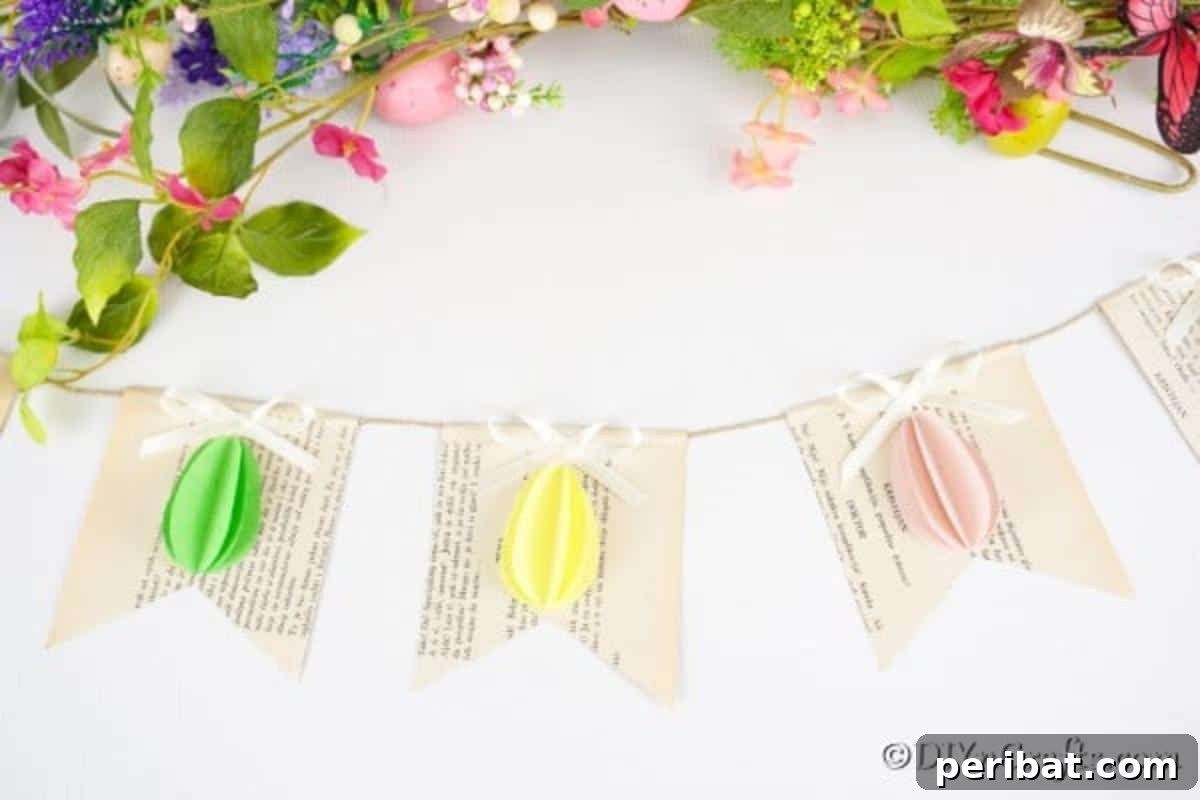 DIY Upcycled Book Page Easter Egg Garland Tutorial 7 Egg garland laying on white surface with fake flowers
