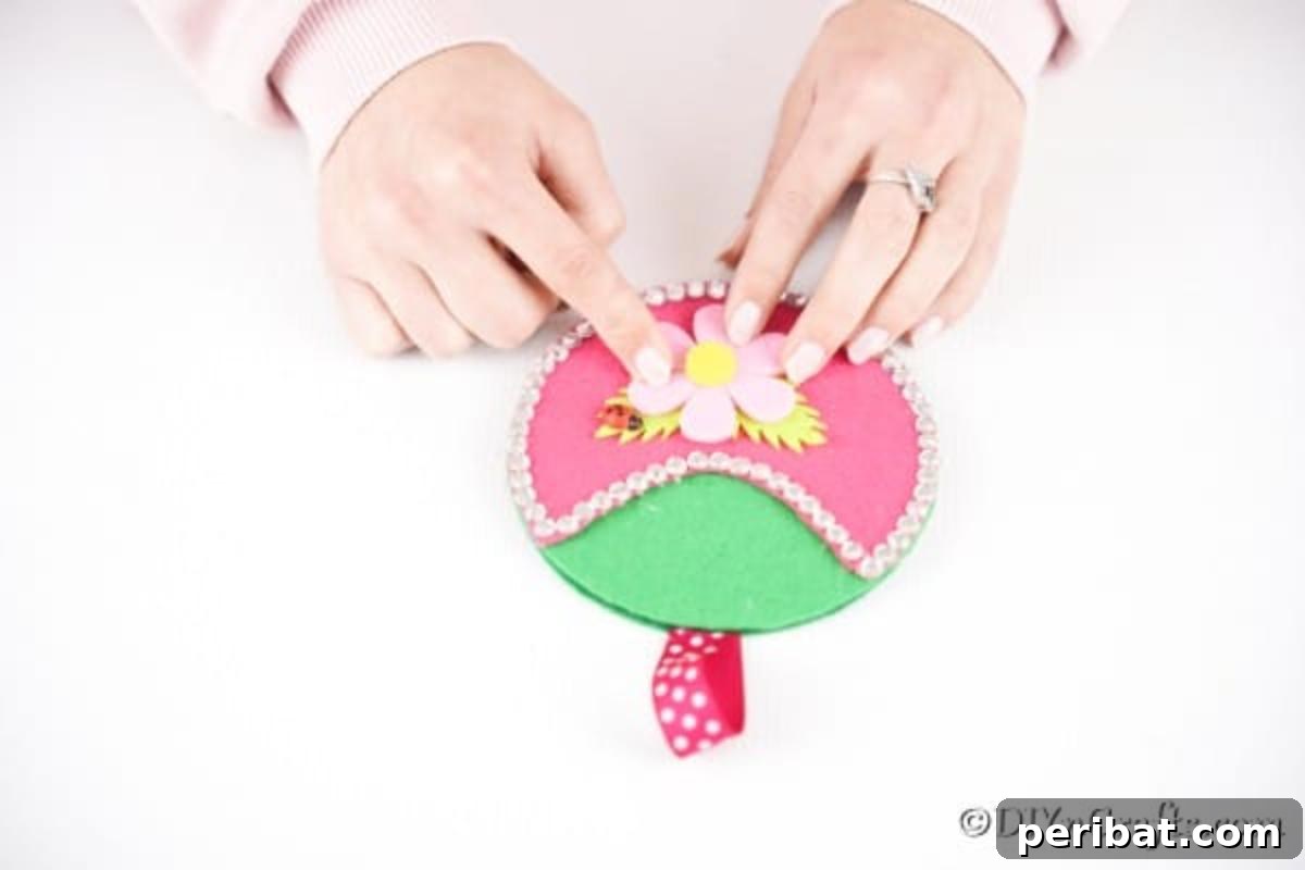 Repurposed CD DVD Wall Storage Pockets 15 Adding flowers to pocket organizer