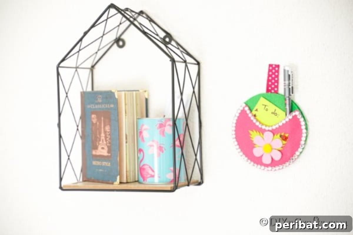 Repurposed CD DVD Wall Storage Pockets 4 Pocket wall organizer on white wall next to wire shelf